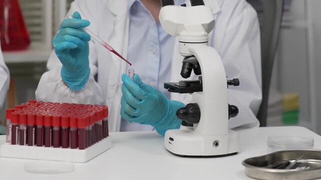 Scientists Hands Holding Blood Sample Vials and Adjusting Microscope in Laboratory