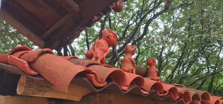 Handmade Clay Figurines Displayed on Terracotta Roof for Decoration