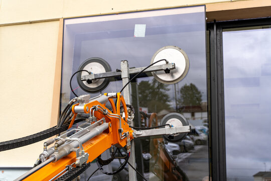 Glass lifting robot with suction cups installing a window