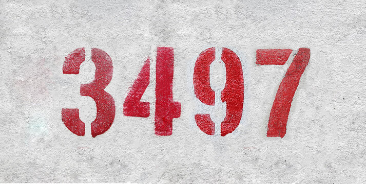 red spray-painted number 3497 sprayed onto a white wall.