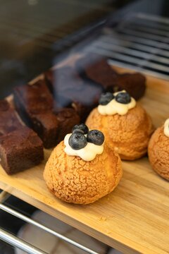 Choux Pastries Topped with Cream and Fresh Blueberries