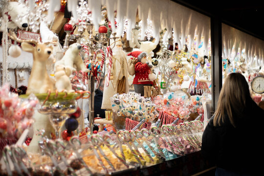Traditional holiday treats and puppets on sale at a Christmas market stand. Background with no people. 