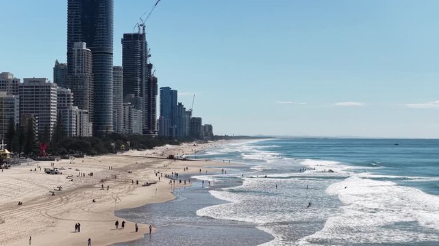 Surfers Paradise aerial view of waves rolling onto golden sand below the towers, Gold Coast, Queensland Australia