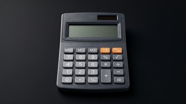 A standard dark gray electronic calculator sitting on a clean black surface for office financial accounting and mathematical business tasks
