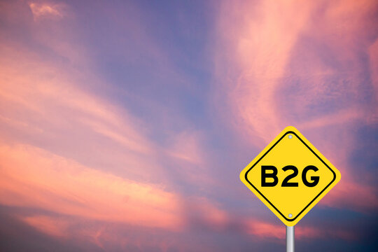 Yellow transportation sign with word b2g (abbreviation of business to government) on violet color sky background