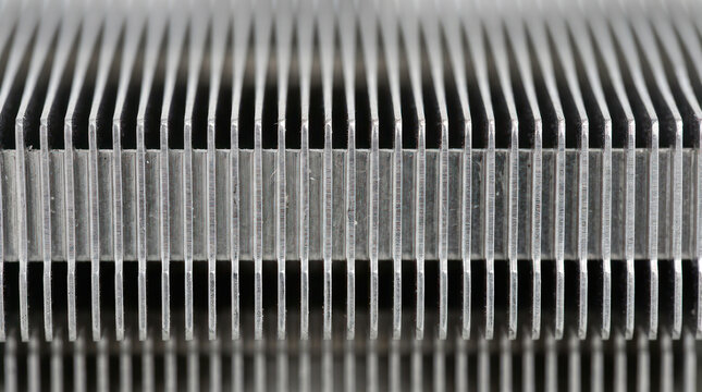 Close up of a metal heatsink with many fins for cooling.
