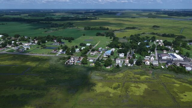 Residential homes surrounded by green farmland landscape living at Bowers Beach by Delaware coastline