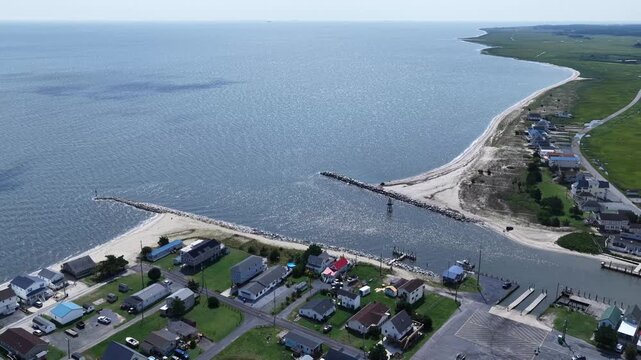 Small fishing community on Delaware coastline at Bowers Beach with marina and inlet waterway with natural wetlands