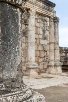 Capernaum, North District, Israel - 08 March 2015: View of the ancient stone columns and ruins of the historic synagogue in Capernaum.