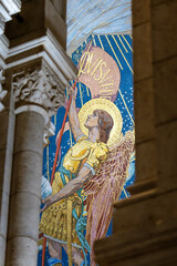 interior religious mural at the sacred-coeur basilica in Paris France with dim soft light on the interior of the cathedral church © STJMEDIA
