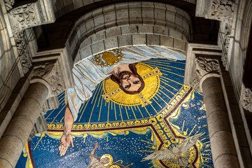 interior religious mural at the sacred-coeur basilica in Paris France with dim soft light on the interior of the cathedral church © STJMEDIA