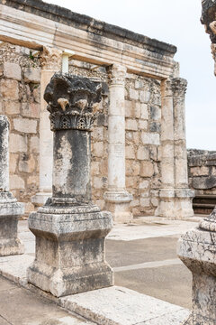 Capernaum, Israel - 08 March 2015: View of the ancient stone columns and ruins of the historic synagogue in Capernaum.