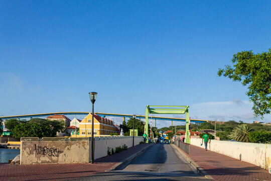 Willemstad, Curacao - 08 November 2014: View of the Queen Emma Bridge and Queen Juliana Bridge with historic colonial buildings and a clear blue sky in Willemstad, Curacao.