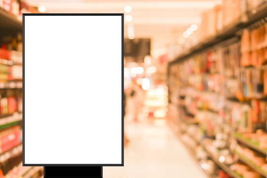 modern blank mockup poster (for ads commercial) standing over blur inside of megastore of local supermarket background in the weekend for billboard design and shopping grocery business concept