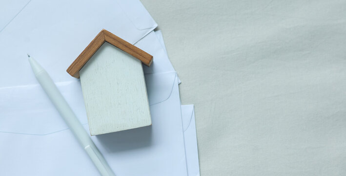 close up of home model and invoice letter on background with space for money management ,home loan and personal financial concept