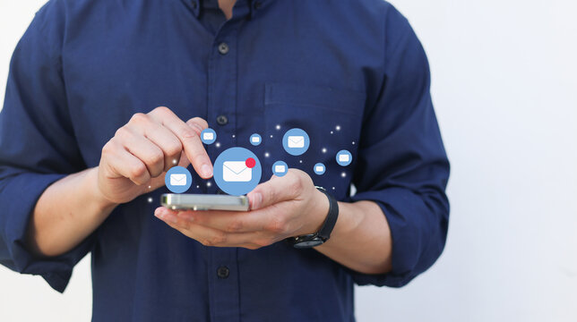 close up businessman holding smartphone and checking email online on web with virtual interface technology concept