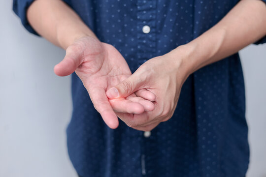 close up adult man massage on his hand and arm for relief pain from hard working on white background at home for stiff or cramp symptom or carpal tunnel syndrome concept