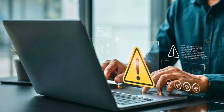 Businessman working on laptop encountering a cybersecurity warning system error or data breach alert