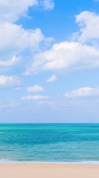 Beautiful tropical sea beach with blue sky and white clouds, vertical background for mobile wallpaper or social media stories
