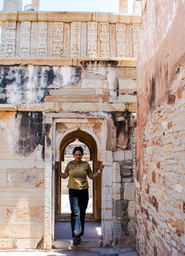 attractive young lady posing with fort at door
