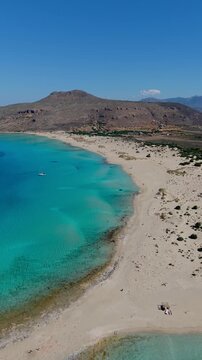 Discover the breathtaking turquoise waters and soft sandy shores of Simos Beach, a hidden gem on Elafonisos Island in Greece. Perfect for sunbathing and relaxation.
