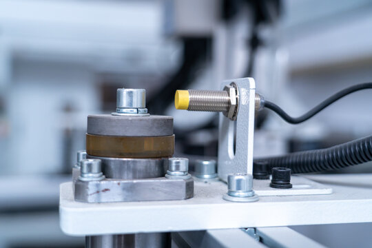 Inductive proximity sensor detecting object on automated industrial machinery