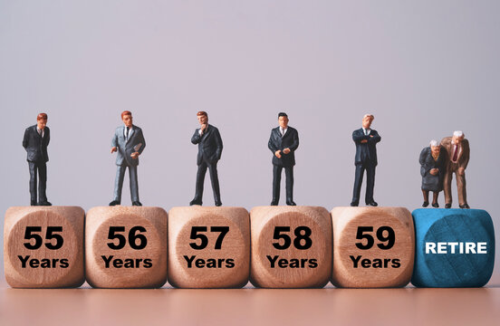 Retirement age concept with miniature people standing on wooden blocks from 55 to 59 years, leading to a retired senior couple, representing pension planning and financial future.