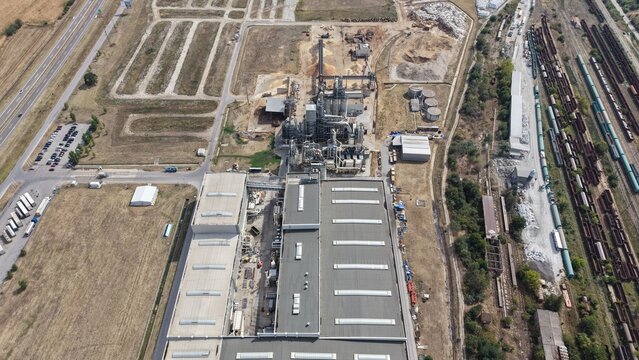 Aerial view of the cardboard and paper factory featuring industrial buildings, storage areas, and adjacent railway tracks in Lapovo, Sumadija District, Serbia.