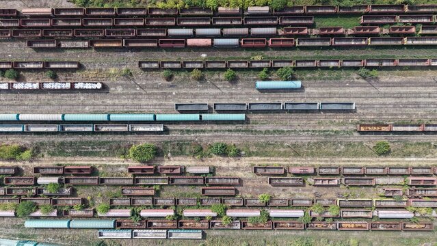 Aerial view of a large railway yard filled with numerous freight train cars parked on parallel tracks in the industrial area of Lapovo, Sumadija District, Serbia.