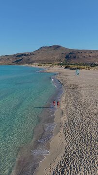 Relax on the golden sands of Simos Beach with crystal-clear waters as the sun shines brightly overhead. Experience the tranquil atmosphere perfect for a summer holiday. Elafonisos Island Greece