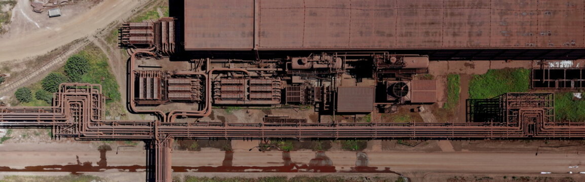 Aerial view of the Smederevo Steelworks featuring complex industrial piping systems, large metal structures, and rusty textures in Smederevo, Podunavlje District, Serbia.