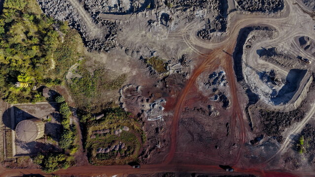 Aerial view of the Smederevo Steelworks showing industrial terrain, raw material piles, storage tanks, and dirt roads in Smederevo, Podunavlje District, Serbia.