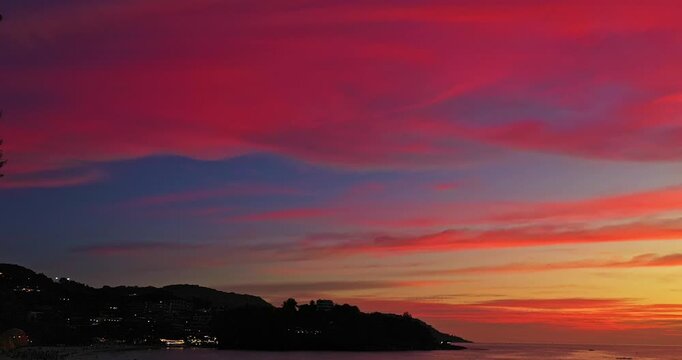 Colorful twilight sky above Pu Island and Kata Beach, Phuket, with dramatic cloud formations, warm sunset light, ocean reflections, and a serene tropical seascape. Beautiful image background.