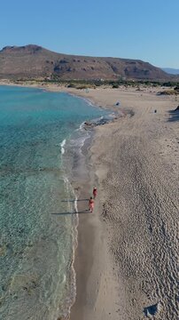 Stunning views of Simos Beach reveal crystal-clear waters and soft golden sands. Enjoy sunbathing, swimming, and peaceful strolls along this tranquil Elafonisos Island, Greece