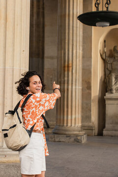 Curly-haired traveler explores Berlins historic architecture with joy