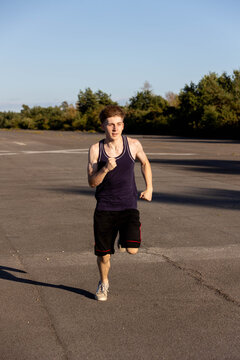 Teenage boy wearing sports clothing running forwards