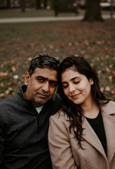 Fototapeta premium Intergenerational family connection and relationship, father and adult daughter bonding outdoors in a park during autumn