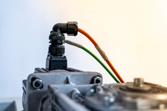 Industrial servo motor connected with bright orange and green cables