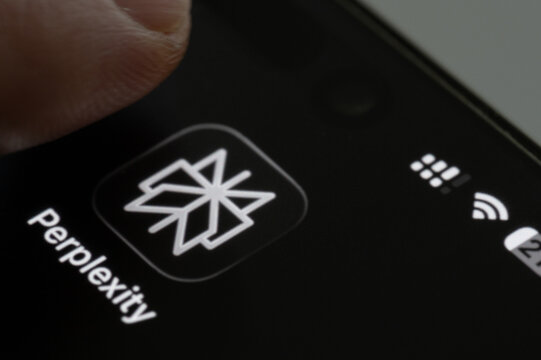 Finger press Perplexity AI app icon