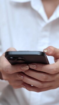 woman holds smart phone in her hands and scrolls through the news feed. Close up of hand uses mobile. point finger on screen, texting text message.	
