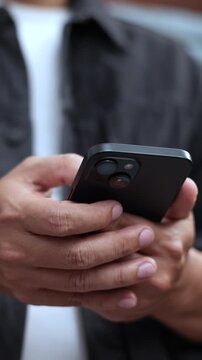 man holds smart phone in her hands and scrolls through the news feed. Close up of hand uses mobile. point finger on screen, texting text message.