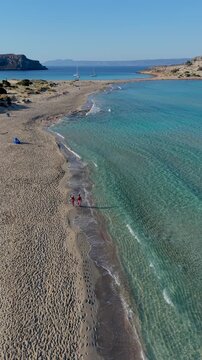 Experience the breathtaking expanse of Simos Beach on Elafonisos Island Greece, where golden sands meet crystal-clear waters. This paradise invites relaxation and exploration under the warm sun.