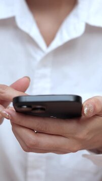 woman holds smart phone in her hands and scrolls through the news feed. Close up of hand uses mobile. point finger on screen, texting text message.	
