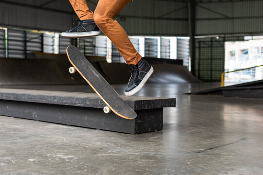 Skateboarder performing trick indoors photo