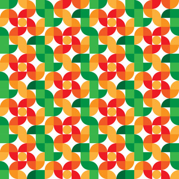 Vibrant geometric seamless pattern with interlocking half-circle shapes in green, orange, and red, creating a dynamic pinwheel design