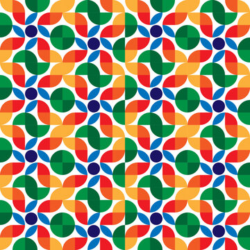 Dynamic geometric seamless pattern with interlocking green, blue, orange, and red half-circle shapes, forming a multi-colored pinwheel design