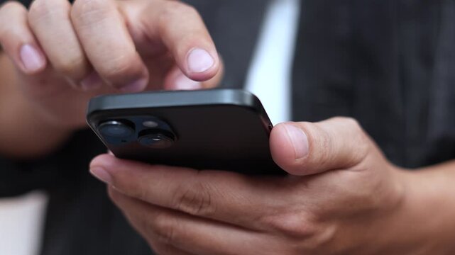 man holds smart phone in her hands and scrolls through the news feed. Close up of hand uses mobile. point finger on screen, texting text message.