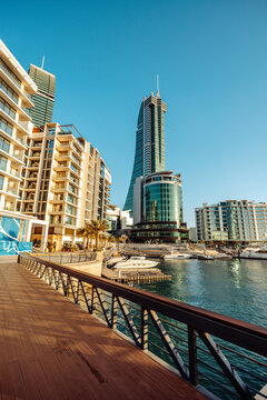 Manama, Capital Governorate, Bahrain - 13 June 2026: View of the modern skyline and waterfront of the Bahrain Financial Harbour with luxury yachts moored at the pier under a clear blue sky.