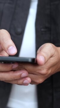 man holds smart phone in her hands and scrolls through the news feed. Close up of hand uses mobile. point finger on screen, texting text message.