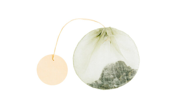 Round mesh tea bag with string and tag filled with loose leaf tea